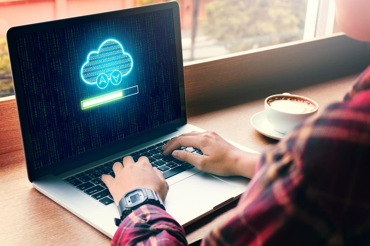 Hands using laptop with cloud computing and uploading files on cloud network server.